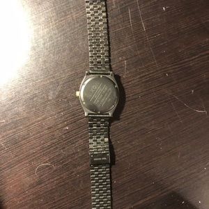 Black and gold Nixon watch